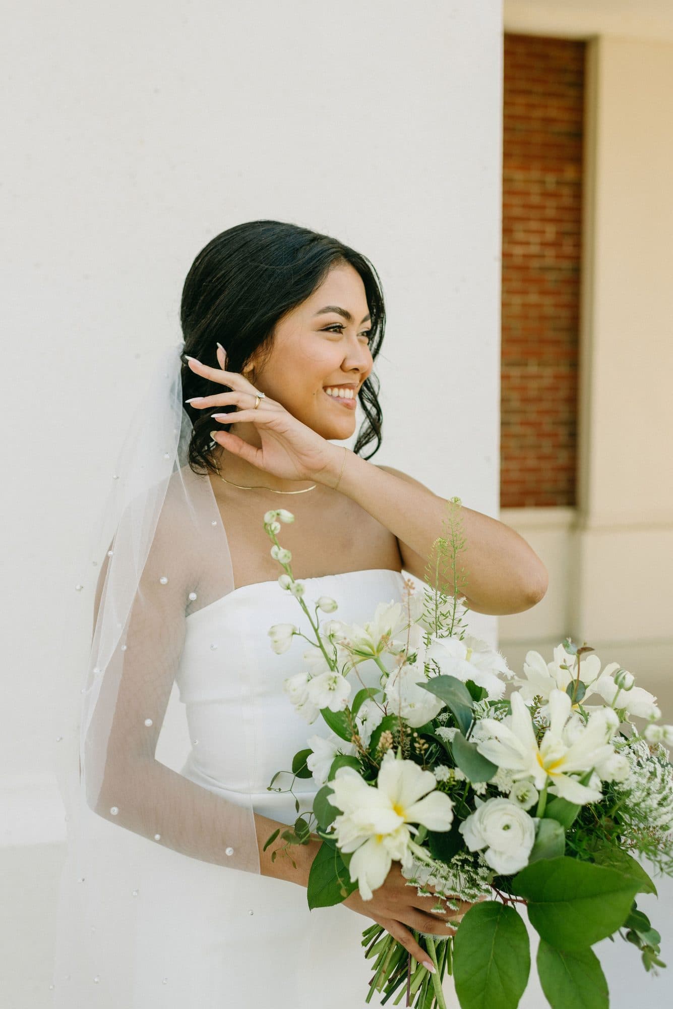 Bride Angeline with soft romantic bridal hair and glowing makeup